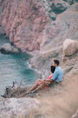 Young Stylish Couple in Love Walking in Mountains by the Sea. Vine Sunset Summer Mood