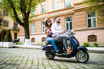 Cheerful young couple riding a scooter in town street with fun © F8  \ Suport Ukraine
