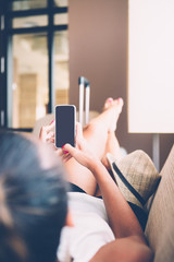 Woman using phone on couch