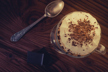 Hot viennese coffee with whipped cream on dark background