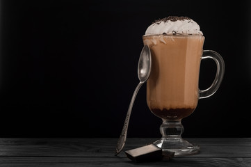 Hot viennese coffee with whipped cream on dark background