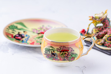 A cup of green tea on a white background. Hot drink