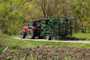 Tractor with cultivator on the rural road