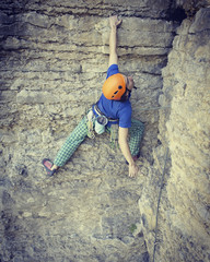 Rock climber reaching for his next hand hold, Joshua Tree National Park.