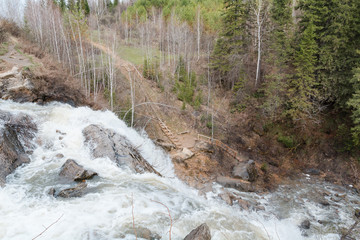Mountain waterfall. Water flows from the rock.