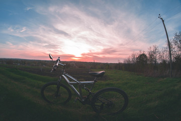 Bicycle on sunset background.