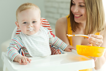 A woman is feeding a child 