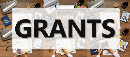 Composition (set) pictures of office items, subjects with text Grants. The woman (businesswoman, manager, student) working at office table (writes, calls, calculates, analyzes). Top view.