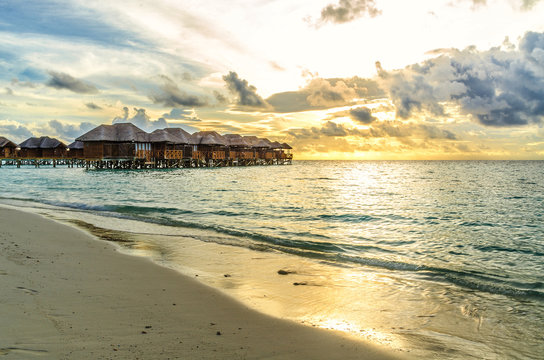 Maldives bungalows at sunset