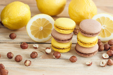 Yellow and brown french macarons with lemon and hazelnuts