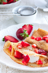 Breakfast with pancakes, fresh strawberries and tea, selective focus