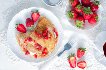 crepes served with cream cheese and fresh strawberry, top view