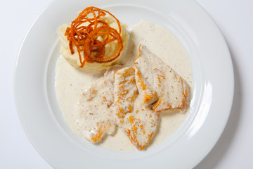 Chicken breast with mashed potato, onion and gravy