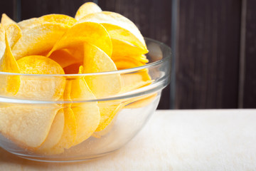 Potato chips in bowl on a table