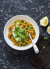 Vegetarian pilaf with chickpeas and fresh herbs on a dark background, top view. Vegetarian food concept