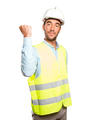 Successful engineer with his fist up against white background