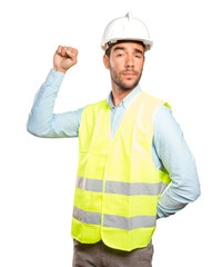 Successful engineer with his fist up against white background