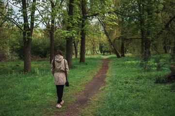 A young girl walking in the green park - 147455592