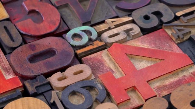 Number abstract in vintage letterpress wood type printing  blocks (mirror image) stained by color inks, rotating background