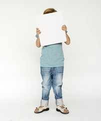 Studio shoot with kid holding blank paper
