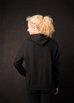 Woman in black hoodie from the back