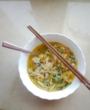 Bowl Of Rice Noodle Soup With A Pair Of Chopsticks.