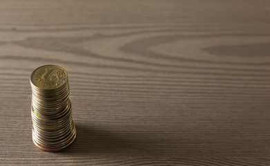 stack of coins on a wooden surface