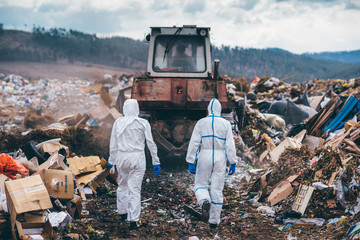 Recycling workers researching on the landfill