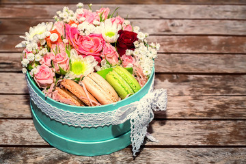 Fototapeta na wymiar Love gift with flowers and macarons
