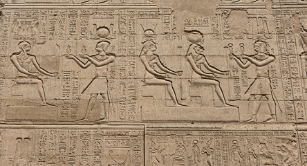 Hieroglyphic carvings on an ancient egyptian temple wall