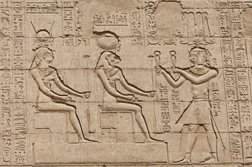Hieroglyphic carvings on an ancient egyptian temple wall