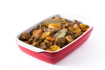 Beef meat stewed with potatoes, carrots and spices in ceramic pot isolated on white background


