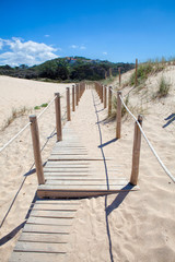 Wooden board path way to the sandy beach