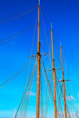 Yacht mast against blue summer sky