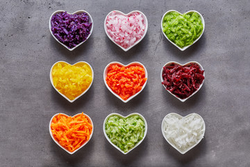 Obraz na płótnie Canvas Heart-shaped bowls with healthy ingredients
