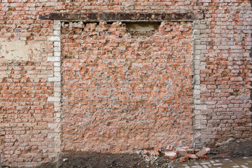 Old broken red brick wall