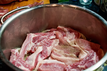 Close up raw pork with onions in pan