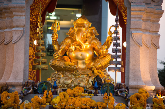 BANGKOK, THAILAND, MARCH 01, 2017 - Golden Ganesha god statue in front of the Central World Plaza. The elephant headed god who is the symbol of success. People always pray him a success life and work.