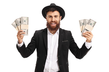 Excited bearded man with bundles of money