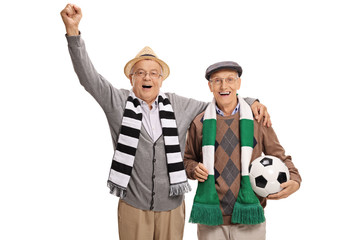 Overjoyed mature soccer fans with scarfs and a football cheering
