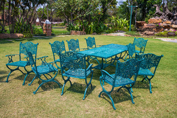 Iron green chairs and table outdoor in the garden