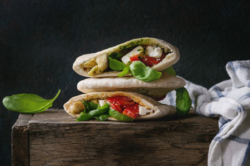 Pita bread sandwiches with grilled vegetables paprika, eggplant, tomato, basil and feta cheese on...