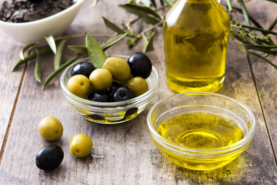 Virgin olive oil in a crystal bowl on wooden background
