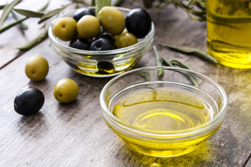 Virgin olive oil in a crystal bowl on wooden background
