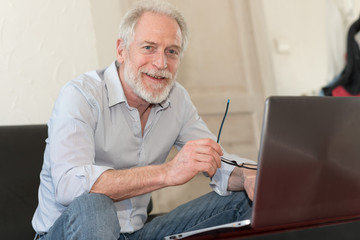 Modern mature man working on laptop