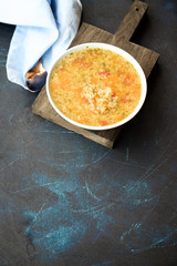 Quinoa soup with carrots, tomatoes, onions and spinach. The concept of healthy diet 
