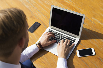 Businessman at work. Close-up top view of man typing on laptop