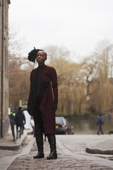 Black Woman in Long Coat Standing in the Street