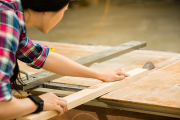 woman working on an electric buzz saw
