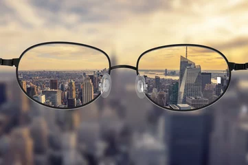 Tuinposter Clear cityscape focused in glasses lenses © Cla78